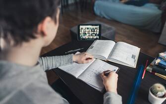 E-Learning from home. Teenage boy studying from home