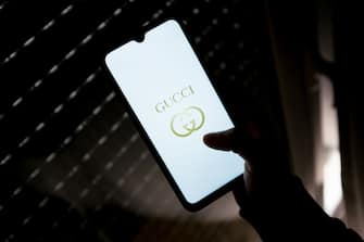 In this photo illustration a Gucci logo seen displayed on a smartphone screen in Athens, Greece on April 2, 2022.  (Photo illustration by Nikolas Kokovlis/NurPhoto via Getty Images)