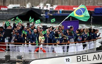 PARIS, FRANCE - JULY 26: Athletes of Team Brazil wave flags on their boat during the opening ceremony of the Olympic Games Paris 2024 on July 26, 2024 in Paris, France. (Photo by Hannah Peters/Getty Images)