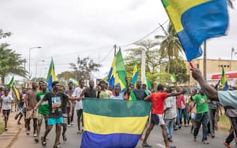 Gabonese people rejoicing in a street in Port-Gentil (economic capital), on August 30, 2023 after the announcement of the Coup d'Etat perpetrated by the Gabonese Defense and Security Forces. President Ali Bongo Ondimba was deposed a few minutes after the announcement of his victory in the presidential elections of August 26, 2023. (Photo by: Desirey Minkoh/Afrikimages Agency/Universal Images Group via Getty Images)