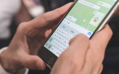 Woman typing on mobile phone