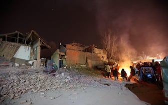 Victims in the earthquake gather around a bonfire in Kangdiao village of Jishishan county in northwest China's Gansu province Tuesday, Dec. 19, 2023. A magnitude-6.2 earthquake jolted the remote and mountainous county around midnight on Tuesday, killing at least 111 people and injuring more than 230, according to Chinese state media.  (Photo by FEATURECHINA/Newscom/Sipa USA)
