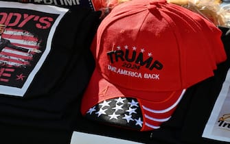 Tee shirts, hats and memorabilia supporter US President Donald Trump is for sale by a vendor who regularly sets up a street stand next to Donald Trump's star on the Hollywood Walk of Fame on January 20, 2025 as Trump's inauguration as the 47th US president. (Photo by Robyn Beck / AFP)