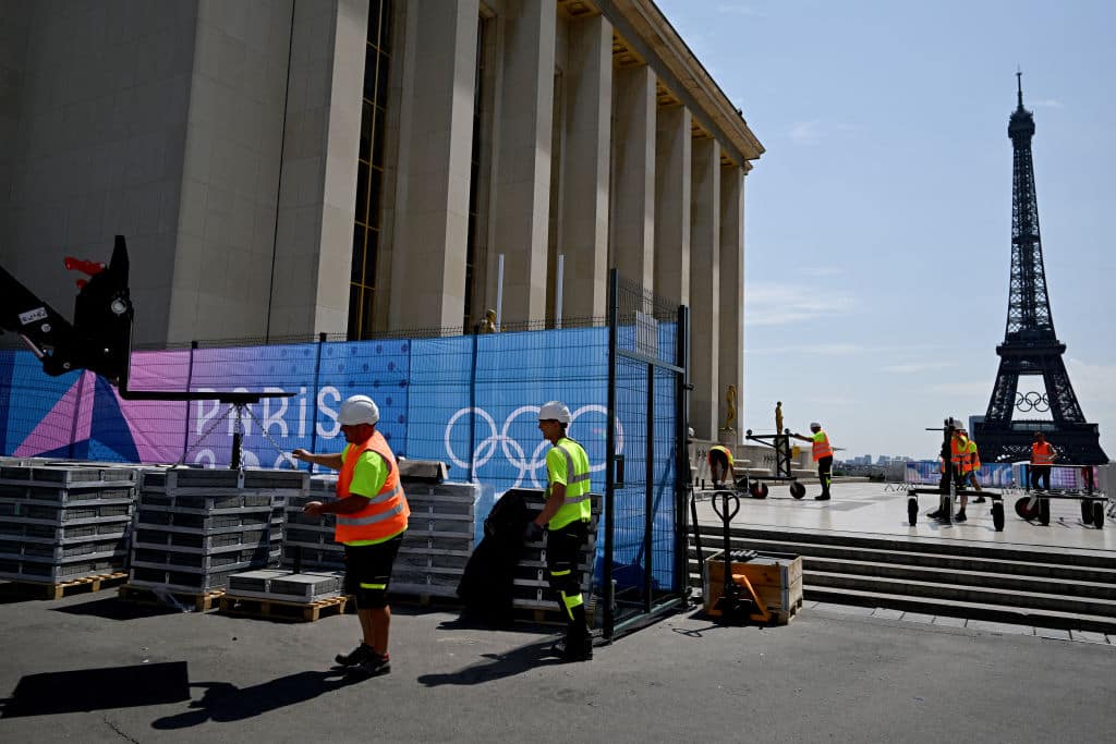 A worker gives instructions for an engine to operate at the Trocadero in front of the Eiffel Tower, ahead of the Paris 2024 Olympic and Paralympic Games, in Paris, on July 19, 2024. (Photo by Gabriel BOUYS / AFP) (Photo by GABRIEL BOUYS/AFP via Getty Images)