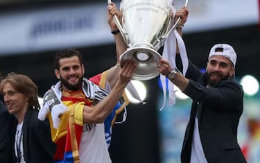 MADRID, SPAIN - MAY 29: Daniel Carvajal (R) of Real Madrid CF holds the trophy in celebration with his teammate Nacho (2ndR) ahead Mateo Kovacic (L) and Luka Modric (2ndL) during their team celebration at Cibeles square after winning the Uefa Champions League Final match agains Club Atletico de Madrid on May 29, 2016 in Madrid, Spain. (Photo by Gonzalo Arroyo Moreno/Getty Images)