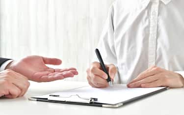 Woman signing contract and business man's hand