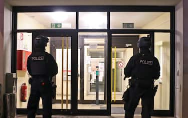 epaselect epa11563550 Two police officers stand guard in front of a refugee center during a police search, in Solingen, Germany, 24 August 2024. A man stabbed passers-by at random with a knife during the city festival in Solingen late 23 August. Three people have been killed and eight others injured, five of them seriously, in the knife attack, police said. Police are currently conducting a large-scale search for the perpetrator. EPA/CHRISTOPHER NEUNDORF