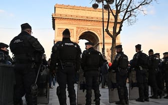 PARIS, FRANCE - MARCH 01: Police officers take security measures during a protest by the French farmers' union in front of the Arc de Triomphe on the Champs-Elysees in Paris, France on March 1, 2024. (Photo by Mustafa Yalçn/Anadolu via Getty Images)