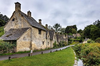 The picturesque weavers cottages at Arlington Row in the Cotswolds village of Bibury in Gloucestershire, England.