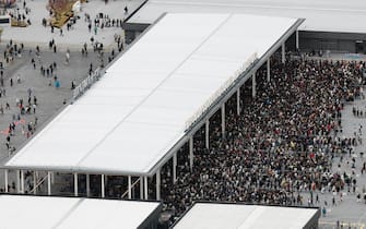epa12028531 This aerial view taken by Jiji Press shows people queuing up at the Osaka Expo 2025 venue the day of its opening at Yumeshima, an artificial island in Osaka, western Japan, 13 April 2025. The Expo 2025 Osaka, Kansai, Japan will be open to the public until 13 October 2025.  EPA/JIJI PRESS JAPAN OUT EDITORIAL USE ONLY/