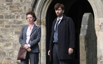 KUDOS FILM AND TV PRESENTS

NEW SERIES

BROADCHURCH 

FOR ITV

EPISODE 4

Pictured :
OLIVIA COLMAN as Ellie Miller and DAVID TENNANT as Alec Hardy

Broadchurch is a new eight part drama series by Kudos Film and Television for ITV. The star-studded cast includes David Tennant, Olivia Colman, Andrew Buchan, Jodie Whittaker, Vicky McClure, Pauline Quirke, Will Mellor, Arthur Darvill and Carolyn Pickles.

This brand new eight part series is written and created by Chris Chibnall (Law and Order: UK, Doctor Who) and will explore what happens to a small community in Dorset when it suddenly becomes the focus of a police investigation, following the tragic and mysterious death of an eleven year old boy under the glare of the media spotlight.

Bloodied and dirty, Danny Latimer (Oskar McNamara) has been found dead on an idyllic beach surrounded by rocks and a jutting cliff-face from where he may have fallen. Whilst his death remains unresolved, the picturesque seaside town of Broadchurch is at the heart of a major police investigation and a national media frenzy.


Copyright: ITV
This photograph is (C) ITV Plc and can only be reproduced for editorial purposes directly in connection with the programme or event mentioned above, or ITV plc. Once made available by ITV plc Picture Desk, this photograph can be reproduced once only up until the transmission [TX] date and no reproduction fee will be charged. Any subsequent usage may incur a fee. This photograph must not be manipulated [excluding basic cropping] in a manner which alters the visual appearance of the person photographed deemed detrimental or inappropriate by ITV plc Picture Desk.  This photograph must not be