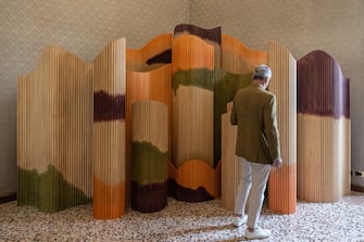 MILAN, ITALY - APRIL 15: A man looks at the "Ensemble" bamboo-made folding screen by Pietrachiara at Palazzo Litta during the Milan Design Week 2024 on April 15, 2024 in Milan, Italy. Every year, the Salone Internazionale del Mobile and Fuorisalone define the Milan Design Week, the worldâ  s largest annual furniture and design event. Centered on principles of circular economy, reuse, and sustainable practices and materials, the Fuorisaloneâ  s 24 theme:Â â  Materia Naturaâ  , seeks to foster a culture of mindful design. (Photo by Emanuele Cremaschi/Getty Images)