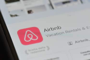 An Airbnb logo (download app page) displayed on a smartphone is seen in L'Aquila, Italy, on september 9th, 2023. Some metropolises and countries are imposing restrictions on Airbnb hosts to protect the hotel industry. (Photo by Lorenzo Di Cola/NurPhoto via Getty Images)