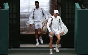 Novak Djokovic and Jannik Sinner walk onto centre court ahead of the Gentlemen's Singles semi-final on day twelve of the 2023 Wimbledon Championships at the All England Lawn Tennis and Croquet Club in Wimbledon. Picture date: Friday July 14, 2023. (Photo by Steven Paston/PA Images via Getty Images)