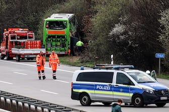 epa11247028 Emergency personnel work at the scene of a bus accident on the A9 highway in Schkeuditz, near Leipzig, Germany, 27 March 2024. At least five people died and several others were injured after a bus operated by FlixBus came off the highway and overturned. According to the company, the circumstances of the accident are not yet known. The bus had left Berlin for Switzerland with two drivers and 53 passengers.  EPA/FILIP SINGER
