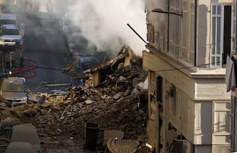 This photograph shows rubbles where a building collapsed in Marseille, southern France, on April 9, 2023. - "We have to be prepared to have victims," the mayor of Marseille warned on April 9, 2023 after a four-storey apartment building collapsed in the centre of France's second city, injuring five people, according to a provisional report. (Photo by NICOLAS TUCAT / AFP) (Photo by NICOLAS TUCAT/AFP via Getty Images)