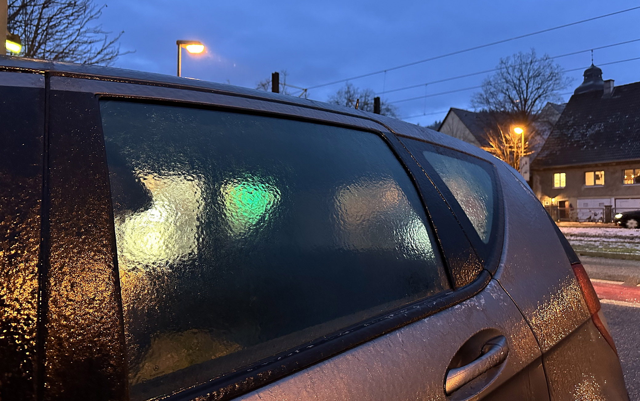 17 January 2024, Baden-Württemberg, Freiburg im Breisgau: Freezing rain has covered a car with a layer of ice. According to the German Weather Service, black ice and severe traffic obstructions are to be expected. Photo: Philipp von Ditfurth/dpa (Photo by Philipp von Ditfurth/picture alliance via Getty Images)