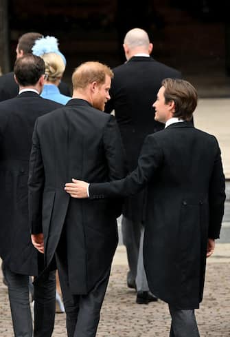 LONDON, ENGLAND - MAY 06:  Prince Harry, Duke of Sussex arrives with Edoardo Mapelli Mozzi to attend the Coronation of King Charles III and Queen Camilla on May 6, 2023 in London, England. The Coronation of Charles III and his wife, Camilla, as King and Queen of the United Kingdom of Great Britain and Northern Ireland, and the other Commonwealth realms takes place at Westminster Abbey today. Charles acceded to the throne on 8 September 2022, upon the death of his mother, Elizabeth II. (Photo by Toby Melville - WPA Pool/Getty Images)