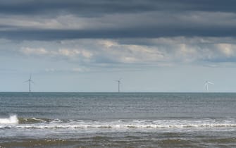 Offshore wind turbines seen from the beach at Cambois, Blyth, Northumberland, UK. Credit: Hazel Plater/Alamy