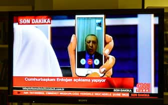 ISTANBUL, TURKEY - JULY 16: Turkish President Recep Tayyip Erdogan speaks on CNNTurk via a Facetime call in the early morning hours of July 16, 2016 in Istanbul, Turkey. Istanbul's bridges across the Bosphorus, the strait separating the European and Asian sides of the city, have been closed to traffic. Reports have suggested that a group within Turkey's military have attempted to overthrow the government. Security forces have been called in as Turkey's Prime Minister Binali Yildirim denounced an 'illegal action' by a military 'group', with bridges closed in Istanbul and aircraft flying low over the capital of Ankara. (Photo by Burak Kara/Getty Images)