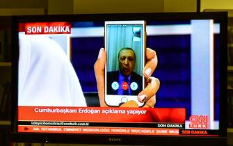 ISTANBUL, TURKEY - JULY 16: Turkish President Recep Tayyip Erdogan speaks on CNNTurk via a Facetime call in the early morning hours of July 16, 2016 in Istanbul, Turkey. Istanbul's bridges across the Bosphorus, the strait separating the European and Asian sides of the city, have been closed to traffic. Reports have suggested that a group within Turkey's military have attempted to overthrow the government. Security forces have been called in as Turkey's Prime Minister Binali Yildirim denounced an 'illegal action' by a military 'group', with bridges closed in Istanbul and aircraft flying low over the capital of Ankara. (Photo by Burak Kara/Getty Images)