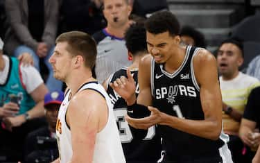 SAN ANTONIO, TX - APRIL 12: Nikola Jokic #15 of the Denver Nuggets is called for a turnover as Victor Wembanyama #1 of the San Antonio Spurs applauds in the first half at Frost Bank Center on April 12, 2024 in San Antonio, Texas. NOTE TO USER: User expressly acknowledges and agrees that, by downloading and or using this photograph, User is consenting to terms and conditions of the Getty Images License Agreement. (Photo by Ronald Cortes/Getty Images)