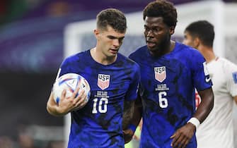 epa10337404 Yunus Musah and Christian Pulisic (L) of USA during the FIFA World Cup 2022 group B match between Iran and USA at Al Thumama Stadium in Al Thumama, Qatar, 29 November 2022.  EPA/JOSE SENA GOULAO