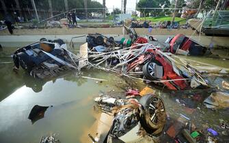 Wreckage of cars remain submerged in the water on October 31, 2024 after flash floods affected the town of Alfafar, in the region of Valencia, eastern Spain. Rescuers raced on October 31, 2024 to find survivors and victims of once-in-a-generation floods in Spain that killed at least 95 people and left towns submerged in a muddy deluge with overturned cars scattered in the streets. About 1,000 troops joined police and firefighters in the grim search for bodies in the Valencia region as Spain started three days of mourning. Up to a year's rain fell in a few hours on the eastern city of Valencia and surrounding region on October 29 sending torrents of water and mud through towns and cities. (Photo by JOSE JORDAN / AFP)