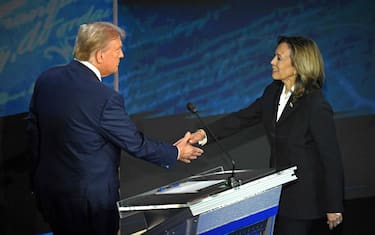 TOPSHOT - US Vice President and Democratic presidential candidate Kamala Harris (R) shakes hands with former US President and Republican presidential candidate Donald Trump during a presidential debate at the National Constitution Center in Philadelphia, Pennsylvania, on September 10, 2024. (Photo by SAUL LOEB / AFP)