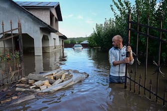 TOPSHOT - A man inspects a flooded house in the Romanian village of Slobozia Conachi on September 14 2024. Storm Boris killed four people in Romania on September 14 2024, as exceptional rains caused flooding in several countries in central and eastern Europe.
Romanian rescue services announced that they had found the bodies of four people during a search operation in the worst-hit region, Galati (southeast), where 5,000 homes were affected. (Photo by Daniel MIHAILESCU / AFP)