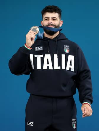 PARIS, FRANCE - AUGUST 09: Bronze medallist Antonino Pizzolato of Team Italy poses on the podium during the Weightlifting Men's 89kg medal ceremony after the Weightlifting Men's 89kg on day fourteen of the Olympic Games Paris 2024 at South Paris Arena on August 09, 2024 in Paris, France. (Photo by Lars Baron/Getty Images)