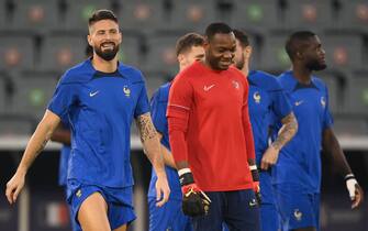 France's forward #09 Olivier Giroud (L) and France's goalkeeper #16 Steve Mandanda take part in a training session at the Al Sadd SC training centre in Doha on December 17, 2022, on the eve of the Qatar 2022 World Cup football final match between Argentina and France. (Photo by FRANCK FIFE / AFP) (Photo by FRANCK FIFE/AFP via Getty Images)