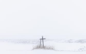 Snow blankets a roadside cross in Williams, Iowa during a blizzard on January 12, 2024. Photo by Julia Nikhinson/ABACAPRESS.COM