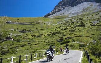 ITALY - JULY 12:  Motorcycles and walker on Stelvio Pass, Passo dello Stelvio, Stilfser Joch, on route Trafoi to Bormio, the Alps, Northern Italy (Photo by Tim Graham/Getty Images)