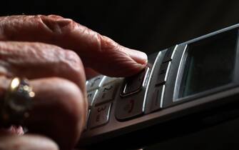 ILLUSTRATION - 11 October 2019, Bavaria, WÃ¼rzburg: An older woman is typing on a cordless landline phone. Photo: Karl-Josef Hildenbrand/dpa (Photo by Karl-Josef Hildenbrand/picture alliance via Getty Images)