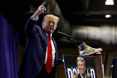 PHILADELPHIA, PENNSYLVANIA - FEBRUARY 17: Republican presidential candidate and former President Donald Trump takes the stage to introduce a new line of signature shoes at Sneaker Con at the Philadelphia Convention Center on February 17, 2024 in Philadelphia, Pennsylvania. Sneaker Con was founded in 2009 and is one of the oldest events celebrating sneakers, streetwear and urban culture. Trump addressed the event one day after a judge ordered the former president to pay $354 million in his New York civil fraud trial. (Photo by Chip Somodevilla/Getty Images)