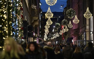 People walk under Christmas lights decorations at the "Quadrilatero della Moda", a high-class shopping district, in Milan on December 2, 2017.  / AFP PHOTO / MIGUEL MEDINA        (Photo credit should read MIGUEL MEDINA/AFP via Getty Images)