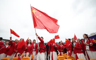 PARIS, FRANCE - JULY 26: Members of the Chinese Olympic delegation wave a China flag on a boat ahead of the Opening Ceremony of the Olympic Games Paris 2024 on July 26, 2024 in Paris, France. (Photo by Cao Can - Pool/Getty Images)