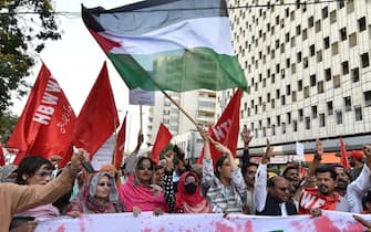 epa11312964 People wave a Palestinian flag during a rally on International Workers' Day, in Karachi, Pakistan, 01 May 2024. Labor Day is annual holiday that takes place on 01 May, it celebrates laborers, their rights, achievements and contributions to society.  EPA/SHAHZAIB AKBER