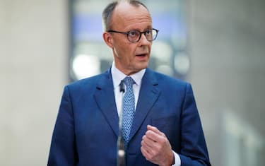 epa11949349 Chairman of the Christian Democratic Union (CDU) party and faction Friedrich Merz gestures at a press conference during ongoing exploratory talks on the premises of the German parliament, the Bundestag, in Berlin, Germany, 08 March 2025. Germany's Christian Democratic Union (CDU) and Social Democratic Party (SPD) continue exploratory talks on forming a potential governing coalition.  EPA/CLEMENS BILAN