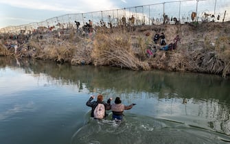EAGLE PASS, TEXAS - JANUARY 07: In an aerial view, immigrants wade across the Rio Grande while crossing from Mexico into the United States on January 07, 2024 in Eagle Pass, Texas. According the a new report released by U.S. Department of Homeland Security, some 2.3 million migrants, mostly from families seeking asylum, have been released into the U.S. under the Biden Administration since 2021. (Photo by John Moore/Getty Images)