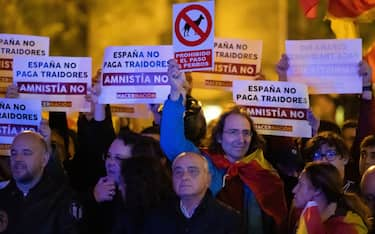 MADRID, SPAIN - 2023/11/09: Demonstrators are seen holding placards during a protest in front of socialist party PSOE headquarters in Ferraz street for the seventh consecutive day of protests following the recent agreement between PSOE and Junts party, which unfolded today in Brussels. Thousands responded to a call by far right groups to protest the approval of an amnesty for Catalan separatist leaders which is included in the agreement and guarantees the investiture of the socialist candidate Pedro Sanchez. (Photo by Marcos del Mazo/LightRocket via Getty Images)