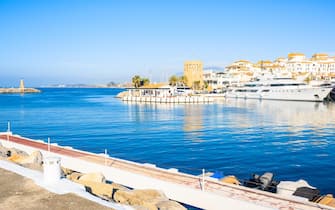 View of Puerto Banus marina with boats and white houses in Marbella town, Andalusia, Spain