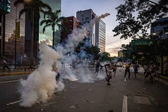 epa11507673 Protesters clash with the Bolivarian National Guard (GNB) over the results of the presidential elections in Caracas, Venezuela, 29 July 2024. Protests are taking place in Caracas after the National Electoral Council (CNE) proclaimed that Nicolas Maduro was re-elected president of Venezuela, following elections held on 28 July. Thousands of citizens have come out to protest against the results announced by the National Electoral Council (CNE), which gave President Maduro 51.2% of the votes, a figure questioned by the opposition and by a good part of the international community. Opposition leader Maria Corina Machado claims they have obtained enough of the vote tallies to prove they won the presidential elections that took place on 28 July.  EPA/Henry Chirinos