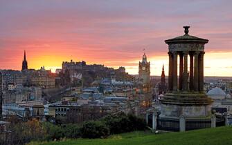 Skyline of Edinburgh from 'Arthur's seat' with sun setting in background