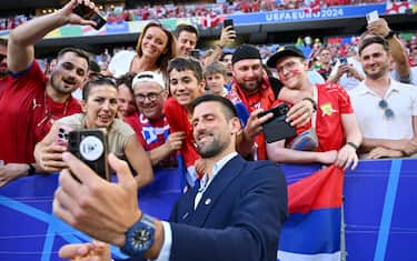 MUNICH, GERMANY - JUNE 25: Serbian tennis player Novak Djokovic poses for a photo with Serbia fans prior to the UEFA EURO 2024 group stage match between Denmark and Serbia at Munich Football Arena on June 25, 2024 in Munich, Germany. (Photo by Sebastian Widmann - UEFA/UEFA via Getty Images)