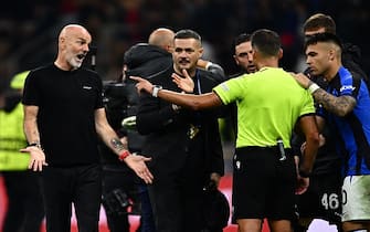 AC Milan's Italian coach Stefano Pioli (L) talks to Spanish referee Jesus Gil Manzano (2ndR) at the end of the UEFA Champions League semi-final first leg football match between AC Milan and Inter Milan, on May 10, 2023 at the San Siro stadium in Milan. (Photo by GABRIEL BOUYS / AFP) (Photo by GABRIEL BOUYS/AFP via Getty Images)