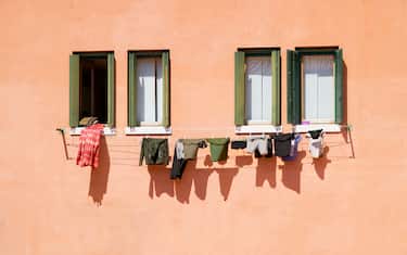 windows with clothes hanging on a facade in Venice, Italy