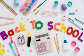 Back to school concept. Creative composition of school stationery  on a white background. Top view, flat lay.