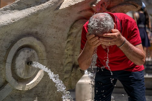 ROME, ITALY - JULY 1: A man cools off in the Barcaccia fountain during an ongoing heatwave with temperatures reaching 40 degrees, at Piazza di Spagna, on July 1, 2025 in Rome, Italy. Rome is one of 17 regions across Italy that have been issued with a Level 3 heat risk for Tuesday, indicating emergency conditions that post a risk to health. Heatwave conditions are forecast to continue across southern Europe throughout the week. (Photo by Antonio Masiello/Getty Images)